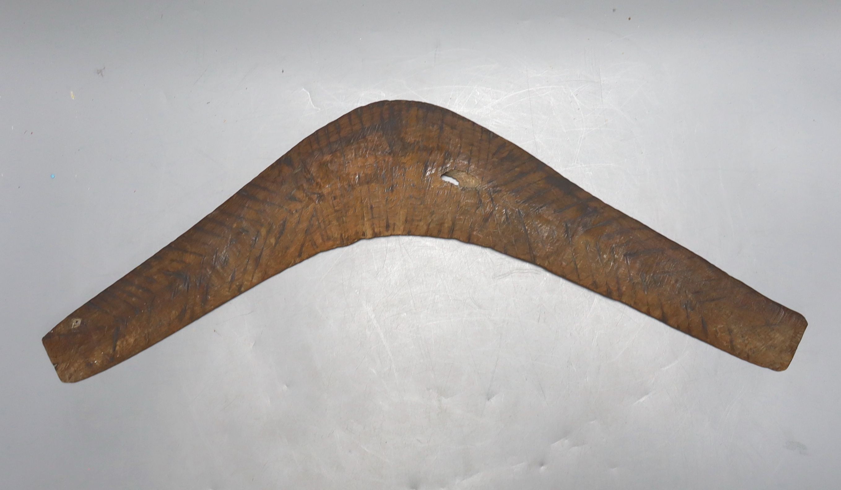 A carved wood boomerang, 19th/20th century, length 50cm